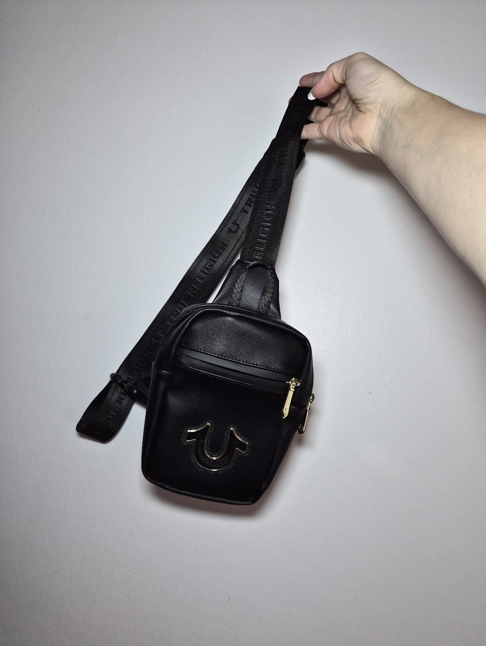 True Religion Black Leather Mini Sling with Gold Emblem Bag
